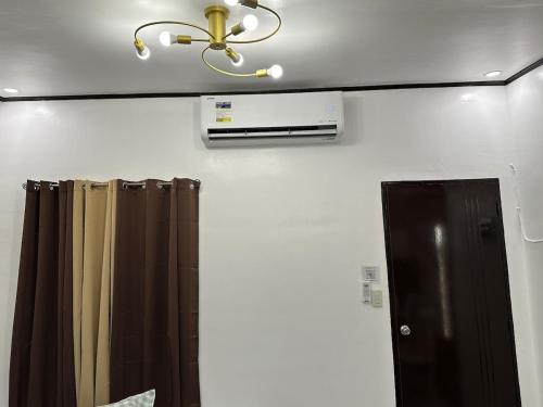 a bathroom with a ceiling fan and a shower curtain at Windmill Bliss in Pililla