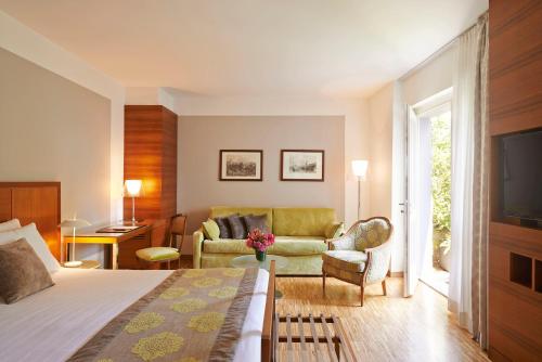 a hotel room with a bed and a living room at Hotel Belvedere in Bellagio