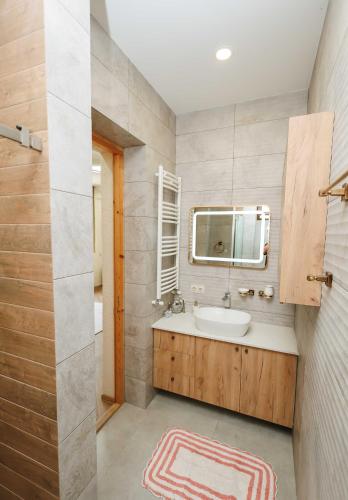 a bathroom with a sink and a mirror at villa aragvi in Aragvispiri