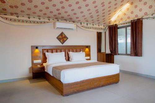 a bedroom with a large bed in a room at Stayguru Road to Heaven Resort in Kunria