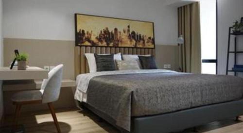a bedroom with a bed and a table and a desk at The Day Residence in Jakarta