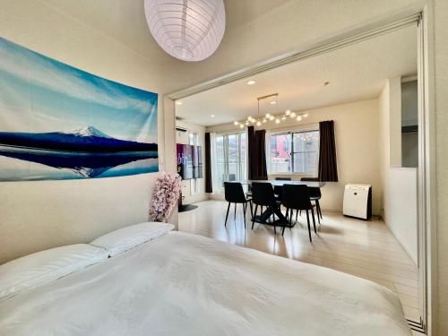a bedroom with a bed and a dining room at Near Ikebukuro! 2min to Kita Ikebukuro Large House in Tokyo