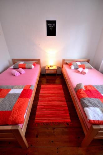 two beds sitting next to each other in a room at Guest House Konjic in Konjic