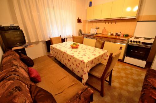 a small kitchen with a table and a table and chairs at Guest House Konjic in Konjic