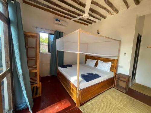 a bedroom with a bunk bed in a room at Zanzibar beach escape 1&2 in Bwejuu