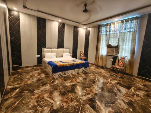 a bedroom with a bed and a marble floor at Hotel O Siddhi Banquet in Juhi Bari
