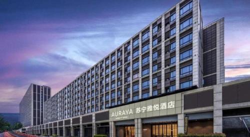 a large building with a sign on the side of it at AURAYA BY SUNING NANJING XUZHUANG in Nanjing