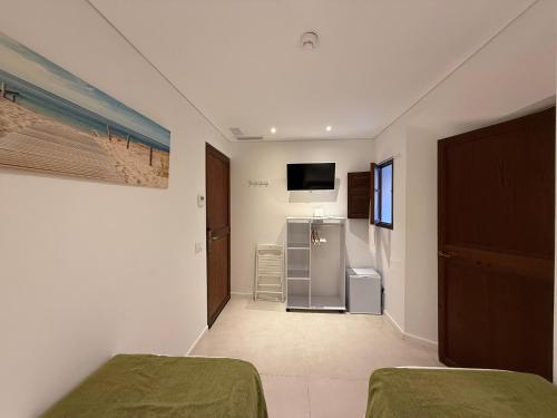a room with two beds and a refrigerator at Marton Valldemossa Turismo de Interior in Valldemossa