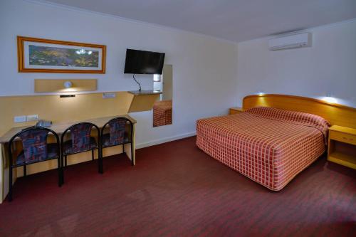 a hotel room with a bed and a flat screen tv at Comfort Inn & Suites Augusta Westside in Port Augusta