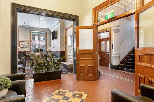 an entrance to a store with a door and a staircase at Quality Inn The George Hotel Ballarat in Ballarat
