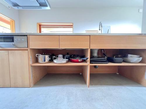 a kitchen with a counter with pots and pans at Yado Nishimura Timeless Japan Experience in Shizuoka