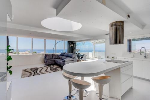 a kitchen with a table and a living room at Panoramic Ocean Mountain View 3 in Adeje