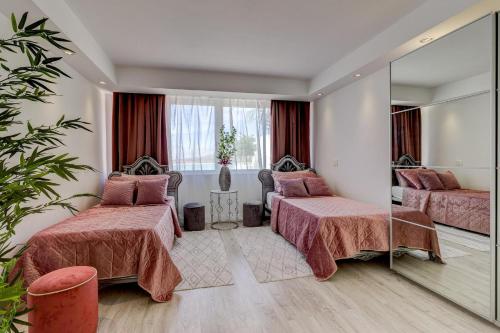 a hotel room with two beds and a mirror at Panoramic Ocean Mountain View 3 in Adeje