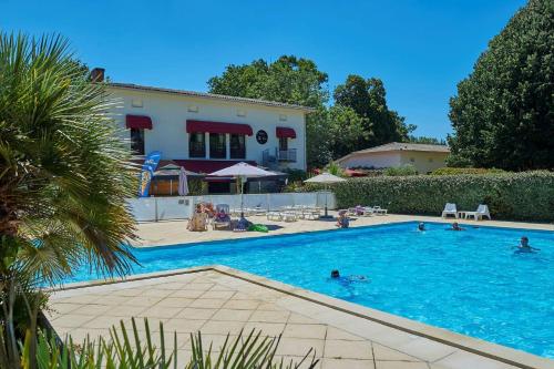 a group of people swimming in a swimming pool at Résidence Château de Salles in Salles