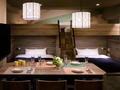 a dining room with a table and two beds at Minn Ueno Iriya in Tokyo