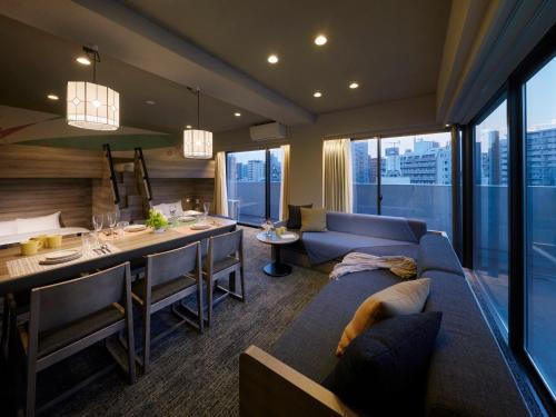 a living room with a couch and a dining room at Minn Ueno Iriya in Tokyo