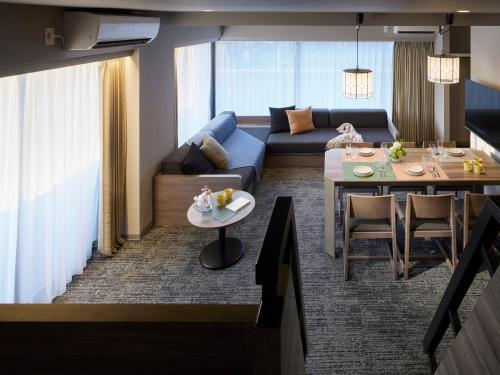 a living room with a couch and a table at Minn Ueno Iriya in Tokyo