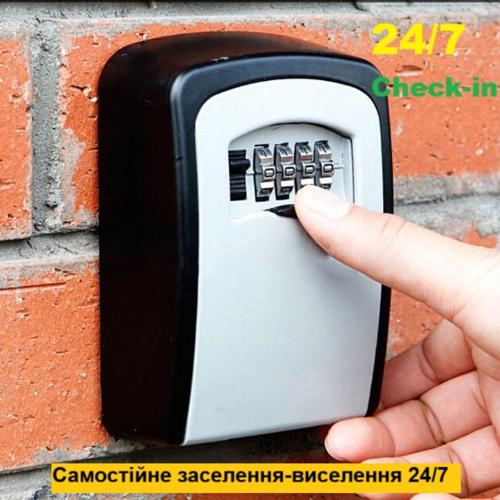 a person holding a cell phone in a brick wall at StudioCaffe - апартаменти з самостійним заселенням біля метро Академіка Павлова in Kharkiv