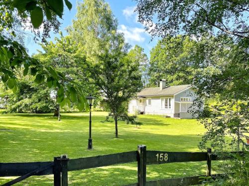 a house with a fence in front of a yard at 6 person holiday home in LJUNGSKILE-By Traum in Ljungskile