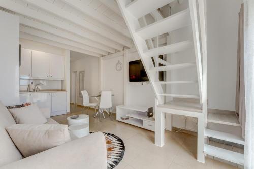 a living room with a white staircase in a room at Yucca Park Apartment in Adeje