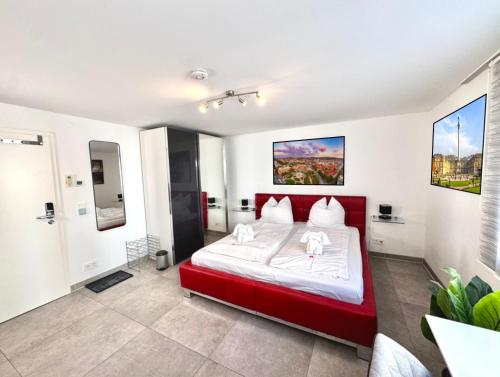 a bedroom with a red bed in a room at Komfort Oase mit Klimaanlage, Terrasse und Whirlpool in Stuttgart