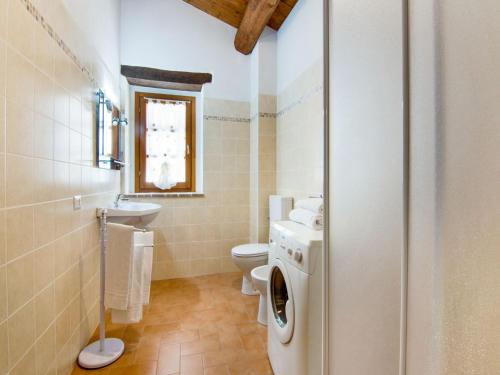 a bathroom with a toilet sink and a washing machine at Holiday Home in Città di Castello with Pool in Città di Castello