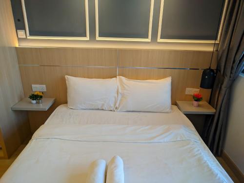 a person laying on a bed in a room at The Luxe & Colony Infinitum KLCC by CoupleStay in Kuala Lumpur