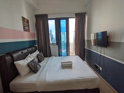a bedroom with a large bed with a balcony at The Luxe & Colony Infinitum KLCC by CoupleStay in Kuala Lumpur
