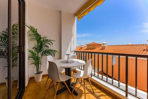 a balcony with a table and chairs and a window at Drilasol 1 Bed Apartment in Puerto de Santiago
