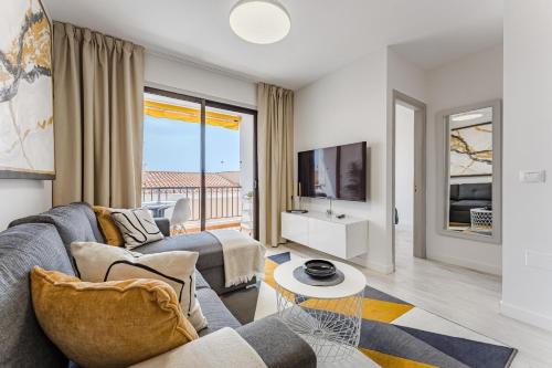 a living room with a couch and a tv at Drilasol 1 Bed Apartment in Puerto de Santiago
