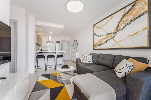 a living room with a couch and a kitchen at Drilasol 1 Bed Apartment in Puerto de Santiago