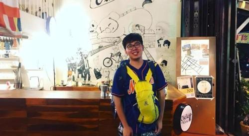 a young man wearing a life vest in a store at Oldie and Sleepy Hostel in Udon Thani