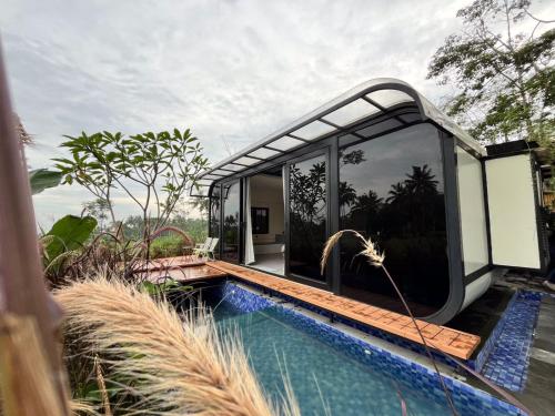 a house with a swimming pool next to a house at Nira Cangkringan Akasha in Bedoyo