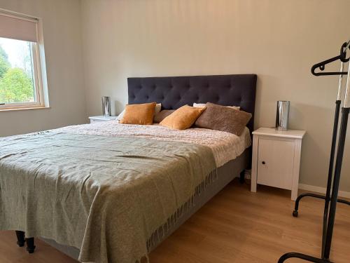 a bedroom with a large bed and a window at Trevlig villa i Hörnett, Örnsköldsvik in Örnsköldsvik