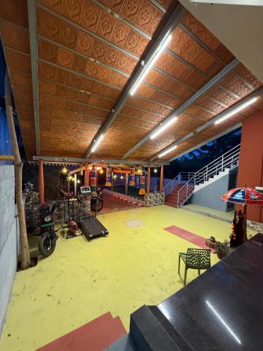 a large room with a motorcycle in a building at Gyani 3 in Tiruvannāmalai