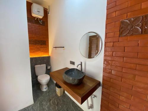 a bathroom with a sink and a toilet at Villa Dewi Sri by MentariPro Bali in Buleleng