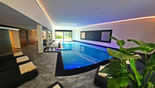 a swimming pool in the middle of a house at Allgäuer Bergwald Chalets in Oberstaufen