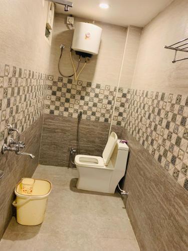 a small bathroom with a toilet and a shower at The Landmark Banjara Hills - Hyderabad in Hyderabad