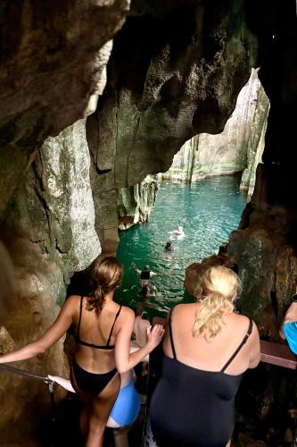 two women walking into a pool of water in a cave at Blue Lagoon Beach Resort in Nacula Island