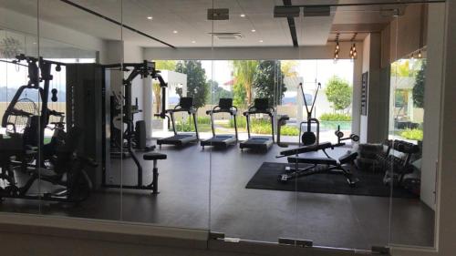 a gym with a row of treadmills and machines at TSYLuxeLoft 4BR Near UKM & Bangi Toll in Bandar Baru Bangi