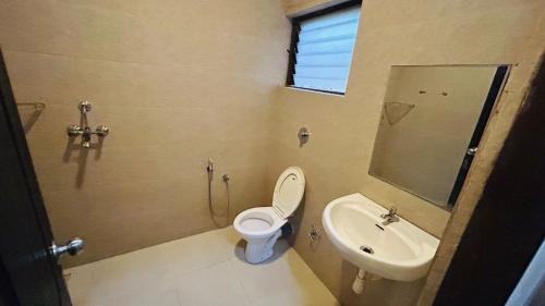 a bathroom with a toilet and a sink at Claudina baga beach in Calangute