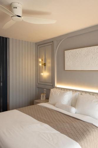 a bedroom with a large bed with white pillows at Penthouse The Olaf at Chiang Mai's Old Town Suandok Gate I Entire Villa Booking I 4 Bedrooms I in Chiang Mai