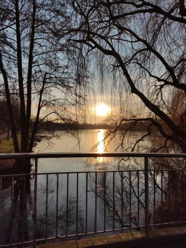 a view of a river with the sun in the background at Ferienhaus kleine Perle in Stendal