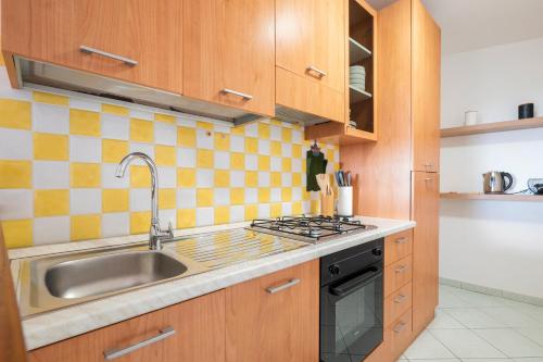 a kitchen with a sink and a stove at Casa Cuccureddu in Jerzu