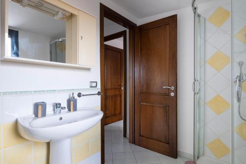 a bathroom with a sink and a shower and a mirror at Casa Cuccureddu in Jerzu