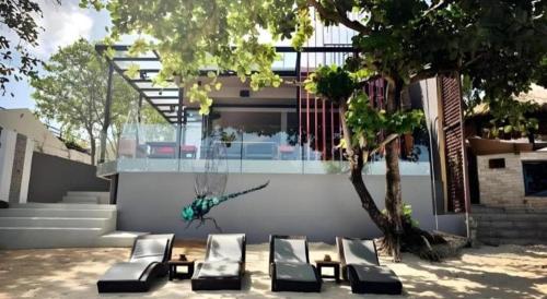 a group of chairs sitting in front of a house at Sea Suite Villa in Chaweng