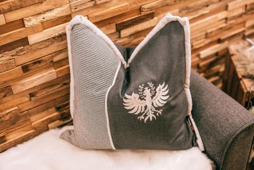 a bag sitting on a chair with a wall at Landhaus Perktold in Nesselwängle