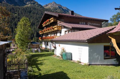 a building with flowers on the side of it at Landhaus Perktold in Nesselwängle