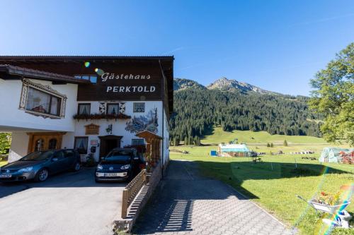 a building with a car parked in front of it at Landhaus Perktold in Nesselwängle