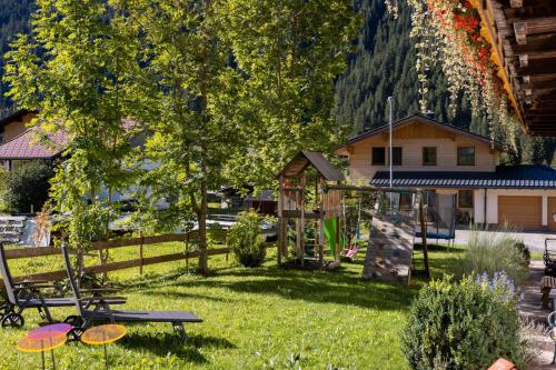 a park with a playground and a tree with frisbees at Landhaus Perktold in Nesselwängle